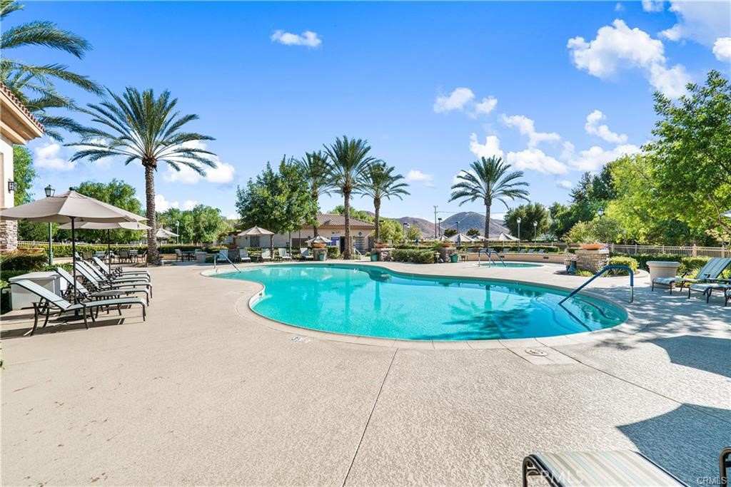 1370 Corte Alamonte Hemet, CA 92545 - Photo 56 of 62 a view of a swimming pool with lounge chair