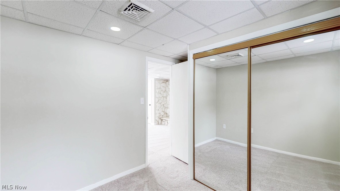 3312 Bancroft Road Akron, OH 44333 - Photo 42 of 50 Finished below grade area with recessed lighting, light colored carpet, and a paneled ceiling