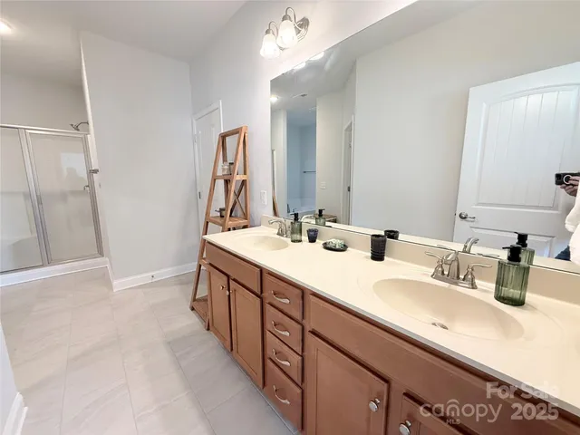 a bathroom with double vanity sinks and a mirror