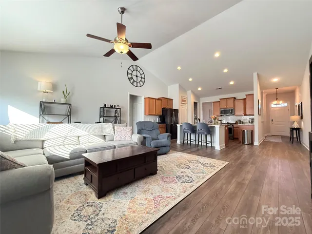 a living room with furniture and a wooden floor
