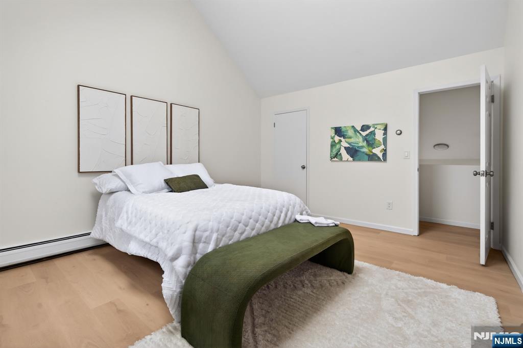 7 Hopson Avenue, Unit B Little Falls, NJ 07424 - Photo 15 of 24 a bedroom with a bed and painting on the wall