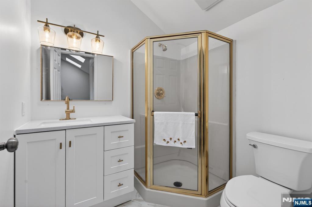 7 Hopson Avenue, Unit B Little Falls, NJ 07424 - Photo 16 of 24 a bathroom with a shower sink vanity and mirror