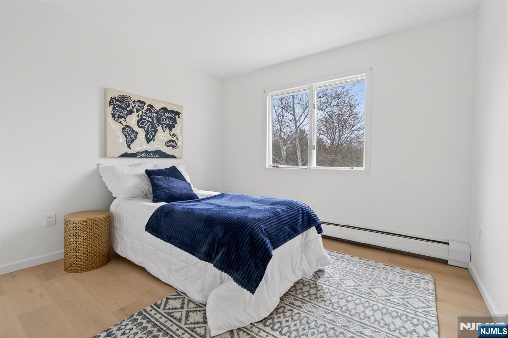 7 Hopson Avenue, Unit B Little Falls, NJ 07424 - Photo 17 of 24 a bed sitting in a bedroom next to a window