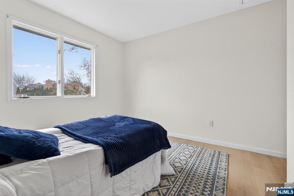 7 Hopson Avenue, Unit B Little Falls, NJ 07424 - Photo 18 of 24 a bedroom with a bed and a window
