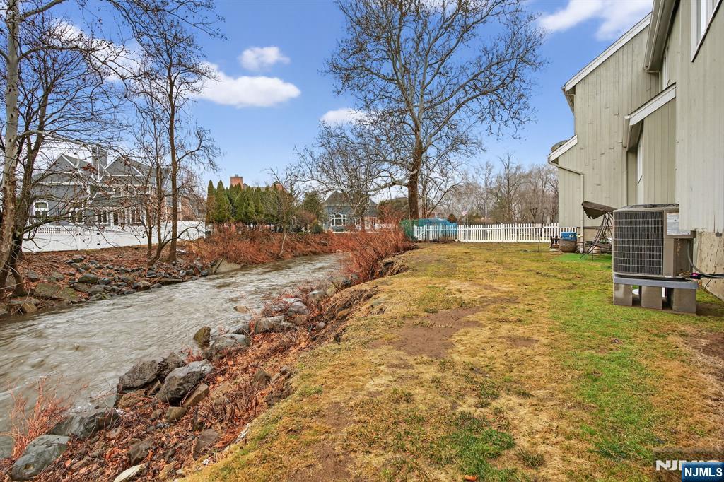7 Hopson Avenue, Unit B Little Falls, NJ 07424 - Photo 22 of 24 a view of a yard with a house and a large tree