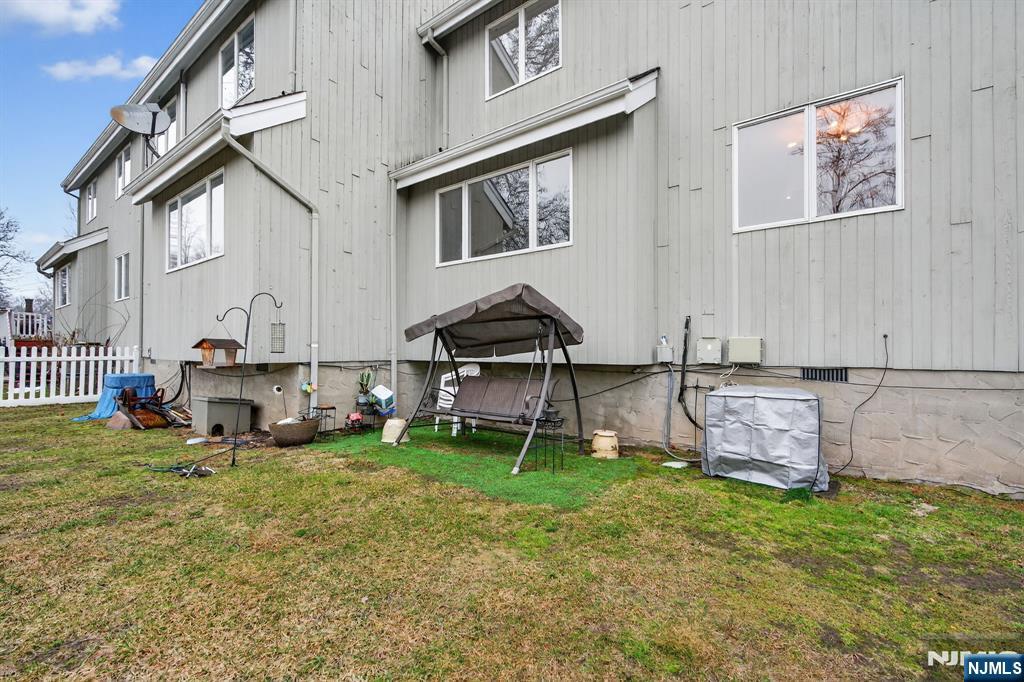 7 Hopson Avenue, Unit B Little Falls, NJ 07424 - Photo 23 of 24 a backyard of a house with table and chairs