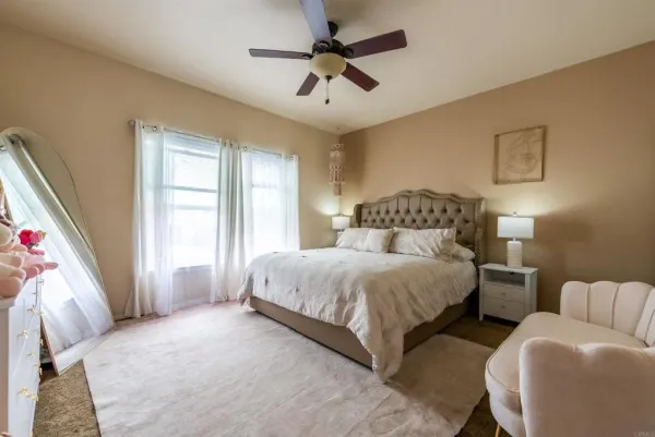 a bedroom with bed and window