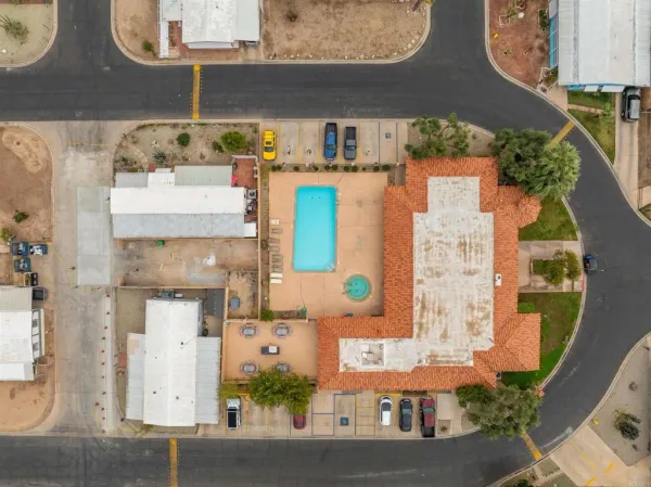 an aerial view of a house with a yard and potted plants