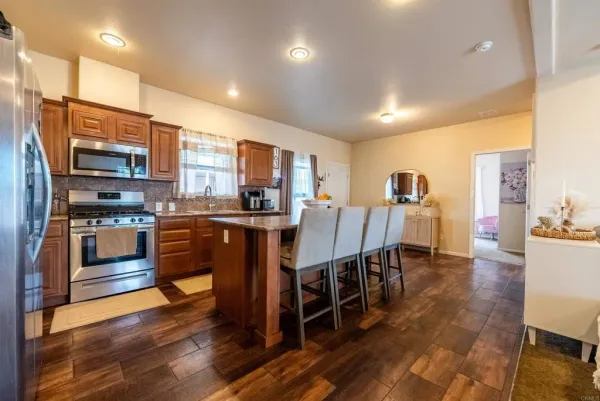 a large kitchen with lots of counter space a sink and appliances