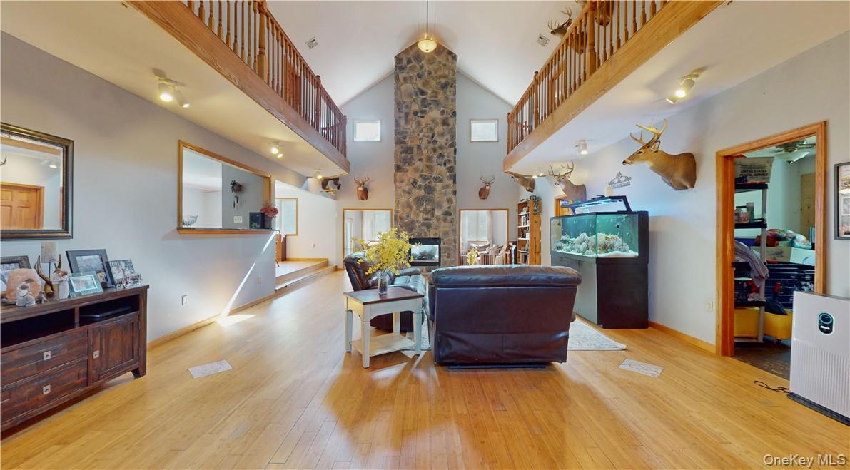75 Monahan Road Port Jervis, NY 12771 - Photo 14 of 36 a living room with furniture and a chandelier