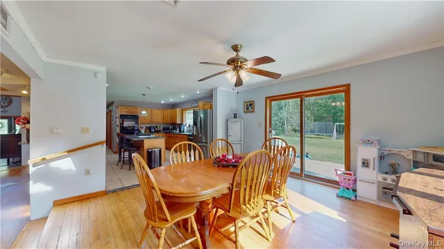 a dining room with furniture a chandelier and wooden floor