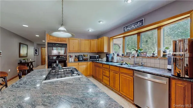 a large kitchen with lots of counter space and a window