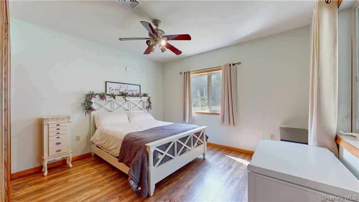 75 Monahan Road Port Jervis, NY 12771 - Photo 21 of 36 a bedroom with a bed and a chandelier