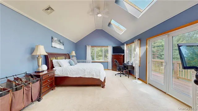 a bedroom with a bed and large windows