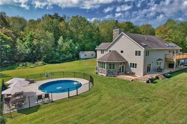 an aerial view of a house with swimming pool garden and patio