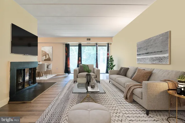 a living room with furniture fireplace and flat screen tv