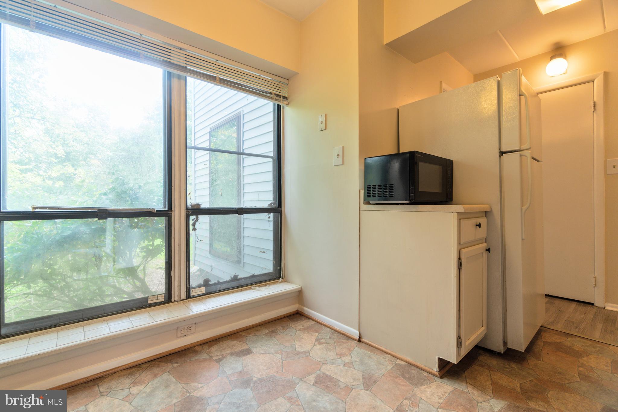 5390 Smooth Meadow Way, Unit B2D02 Columbia, MD 21044 - Photo 13 of 28 a view of a kitchen with a sink and a large window