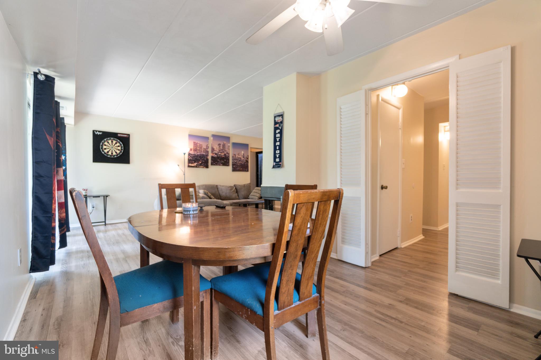 5390 Smooth Meadow Way, Unit B2D02 Columbia, MD 21044 - Photo 15 of 28 a view of a dining room with furniture and wooden floor
