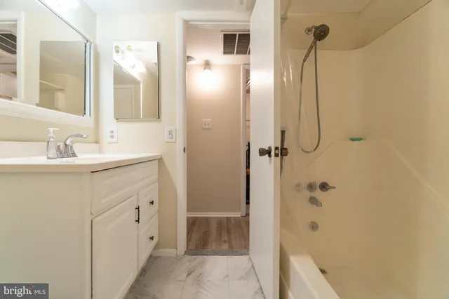 a bathroom with a shower sink and mirror