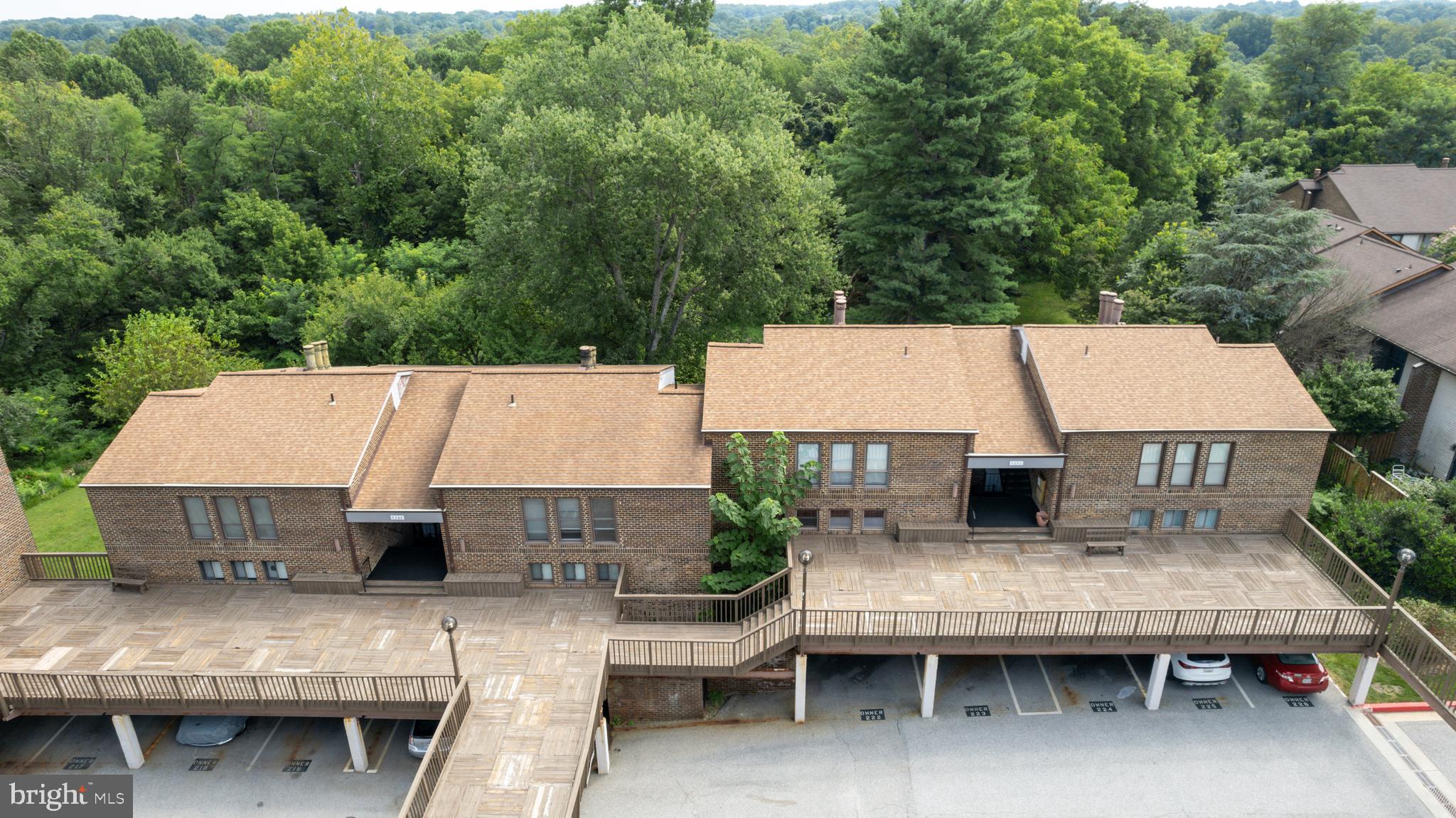 5390 Smooth Meadow Way, Unit B2D02 Columbia, MD 21044 - Photo 22 of 28 a view of a patio with table and chairs a barbeque with wooden floor and fence