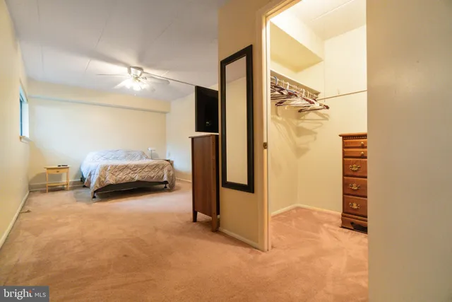 a view of a bedroom with closet and door