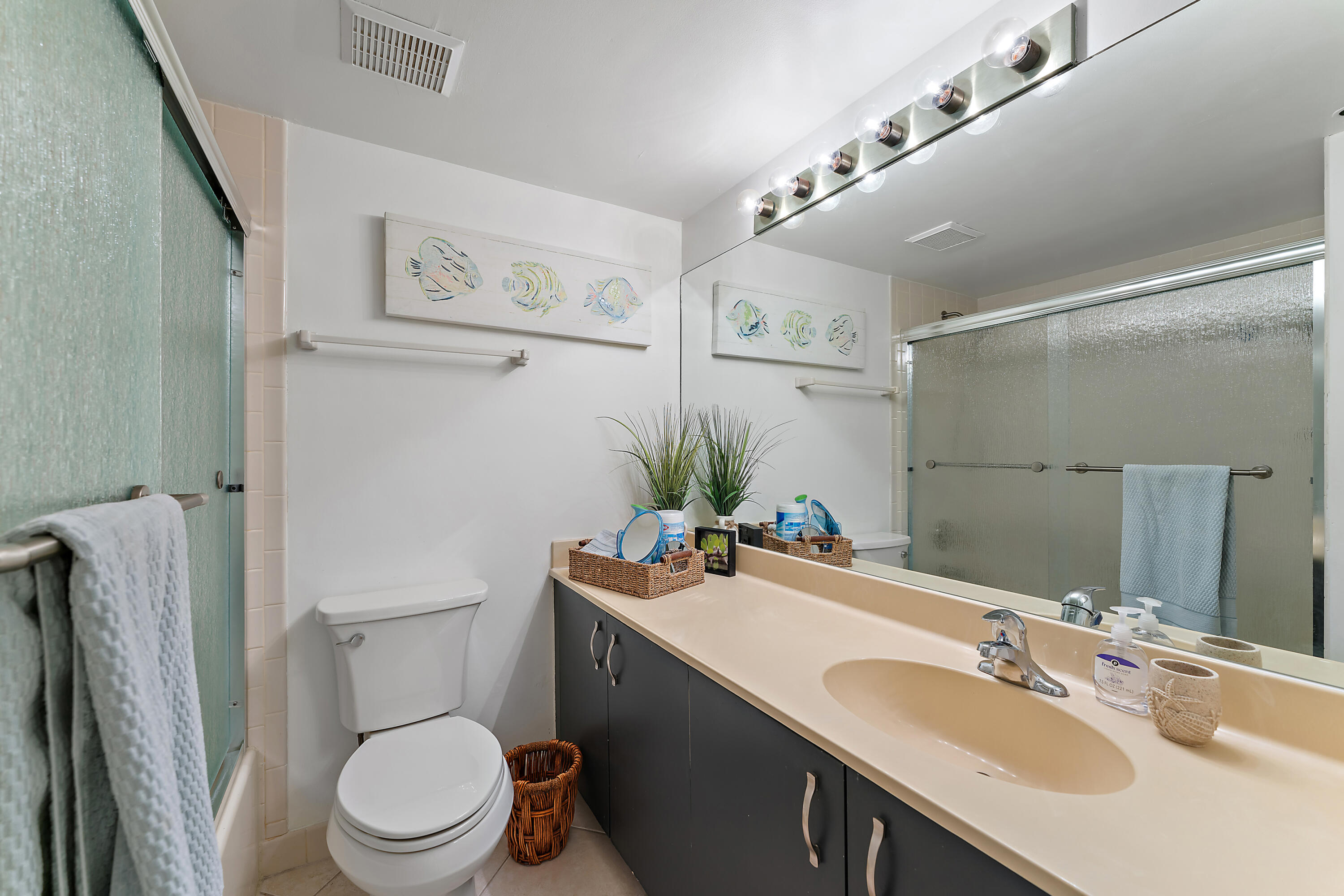 275 Palm Avenue, Unit C503 Jupiter, FL 33477 - Photo 9 of 10 a bathroom with a sink toilet and vanity