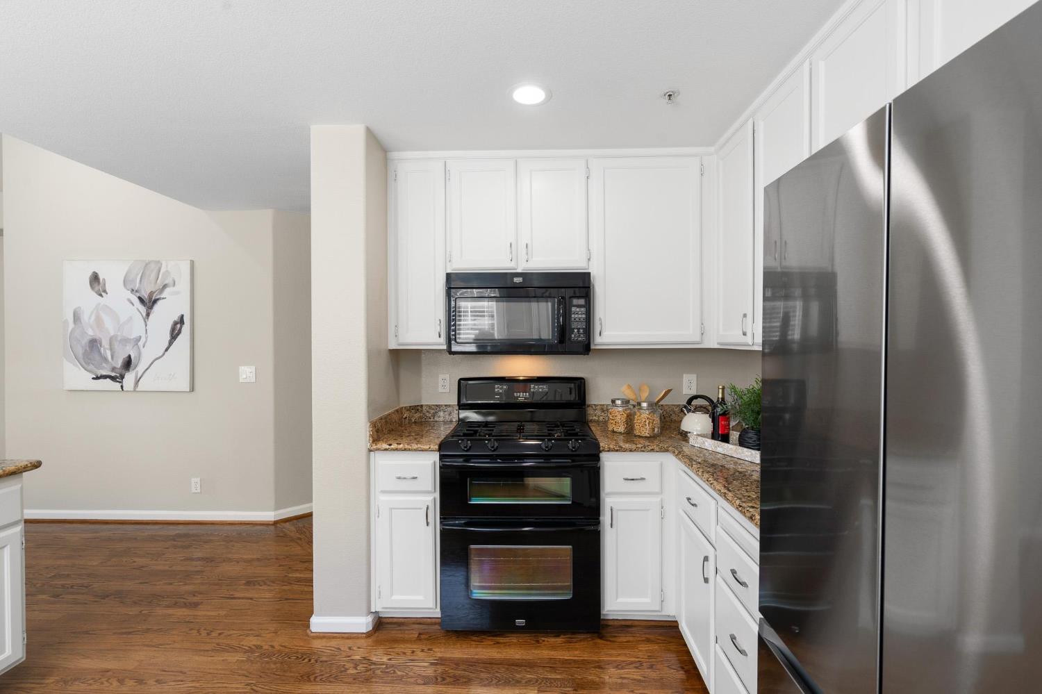 1363 Rincon Avenue Livermore, CA 94551 - Photo 18 of 65 a kitchen with a refrigerator and a stove top oven