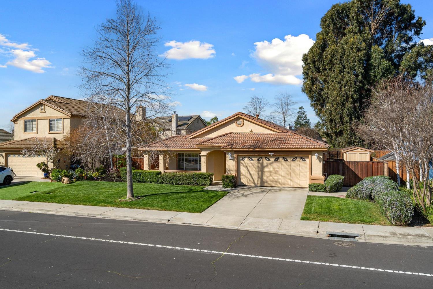 1363 Rincon Avenue Livermore, CA 94551 - Photo 4 of 65 a front view of a house with a garden and trees