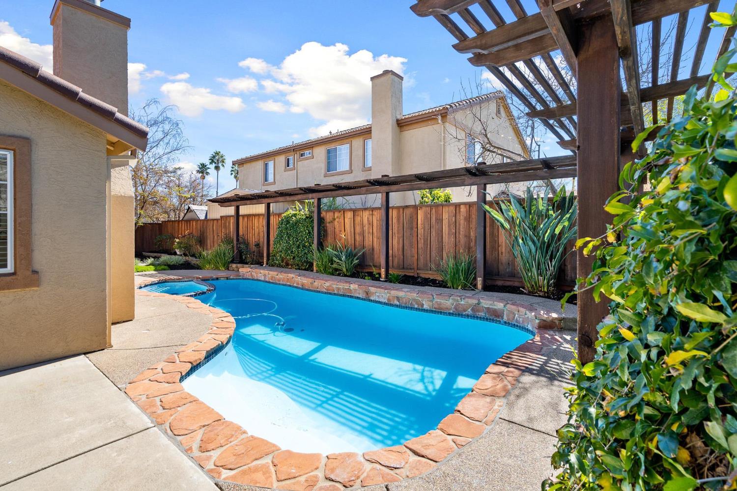 1363 Rincon Avenue Livermore, CA 94551 - Photo 55 of 65 a view of swimming pool in front of residential houses with wooden fence