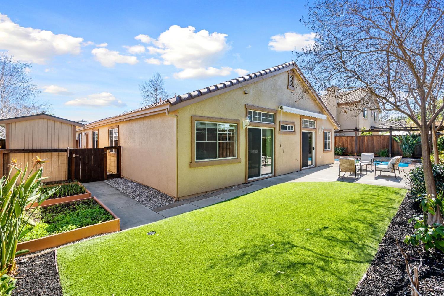 1363 Rincon Avenue Livermore, CA 94551 - Photo 62 of 65 a view of a house with backyard sitting area and garden