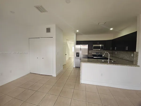 a view of a backyard with wooden fence