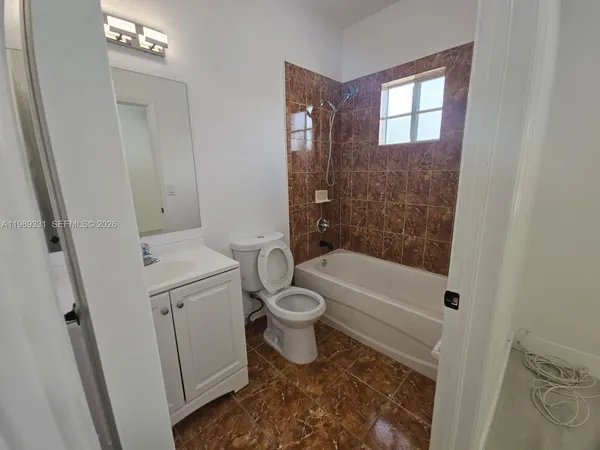 a bathroom with a sink toilet and mirror