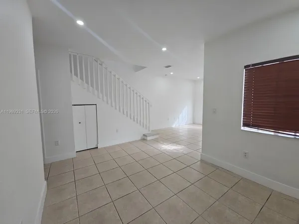 a view of an empty room and stairs