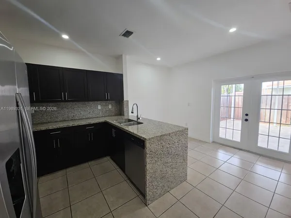 a kitchen with stainless steel appliances granite countertop a stove and a sink