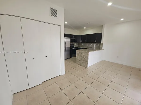 a view of kitchen with microwave and cabinets