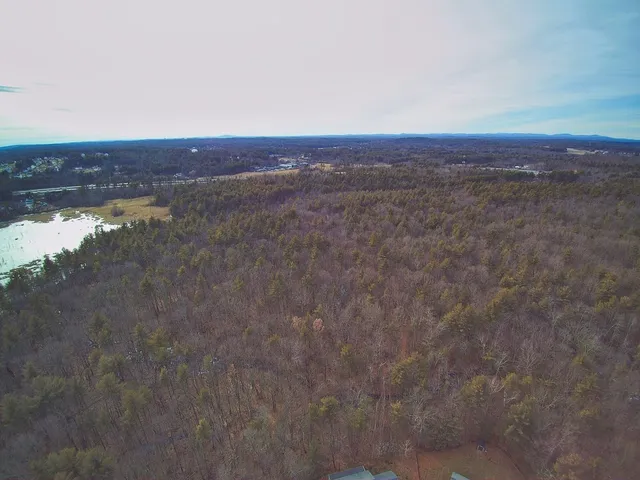 a view of a room with an empty space and a window