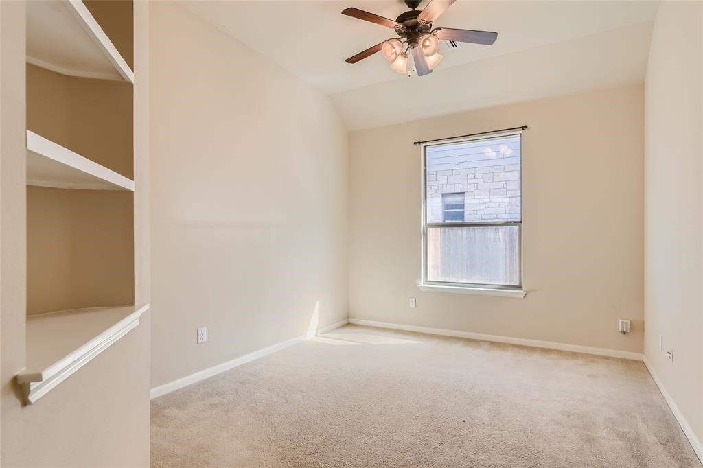 290 Maeves Way Austin, TX 78737 - Photo 13 of 13 Integrated shelving and soft carpet flooring complement this airy, well-lit room.
