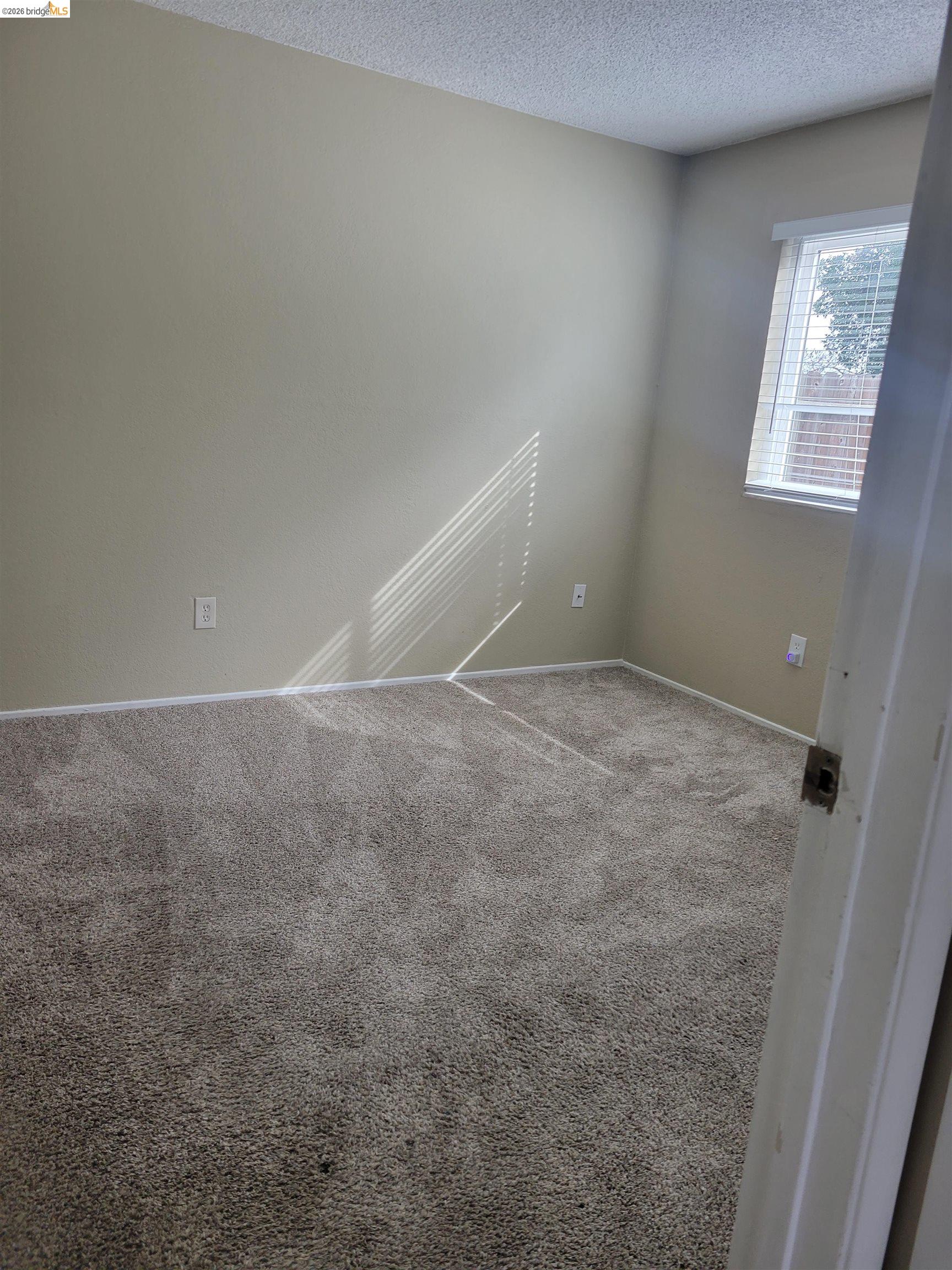 906 Coral Drive Rodeo, CA 94572 - Photo 10 of 21 an empty room with windows
