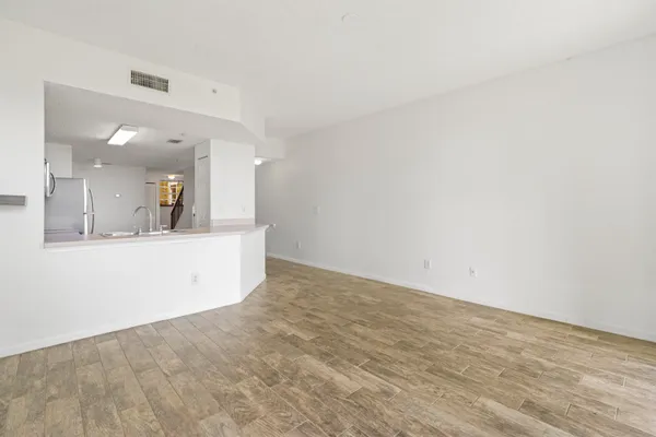 a view of a kitchen with a sink and mirror