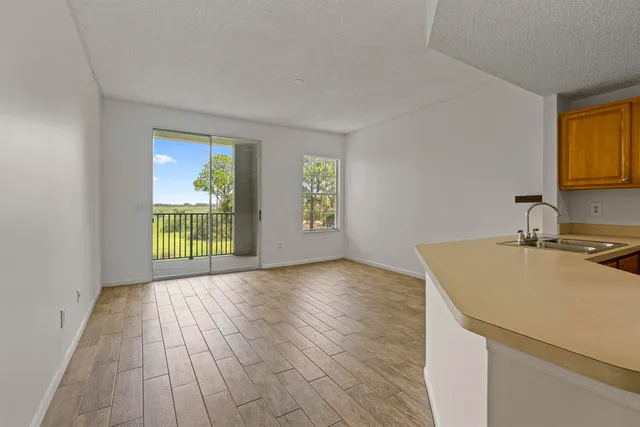 a view of a kitchen with wooden floor and sink