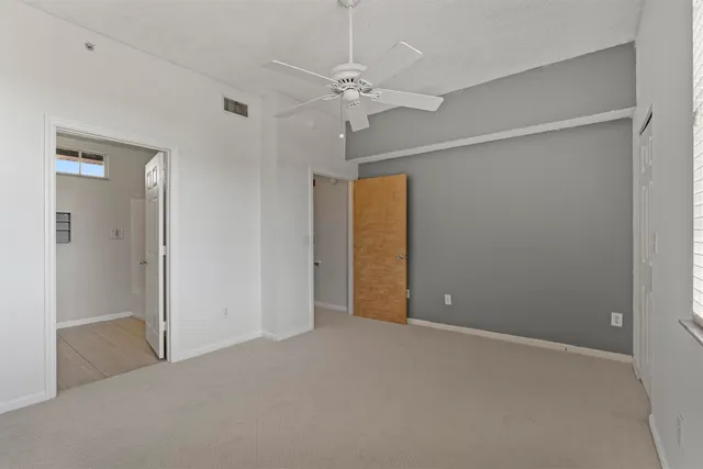 a view of a room with a ceiling fan