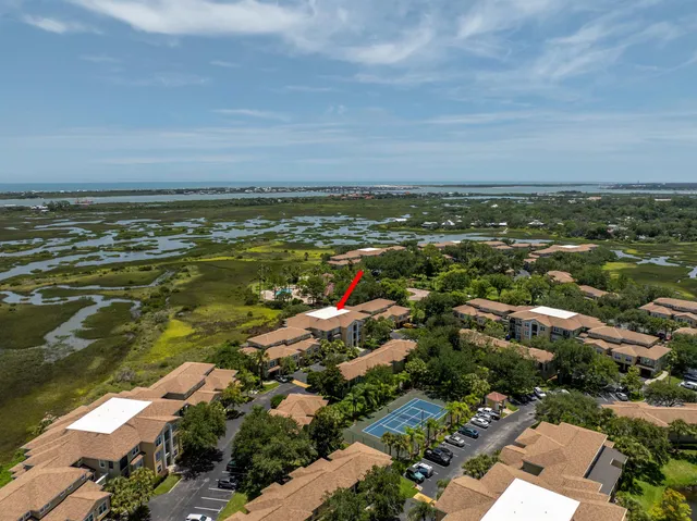 an aerial view of residential building and ocean