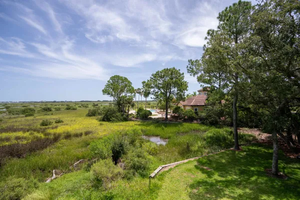 a view of a garden with a building in the background