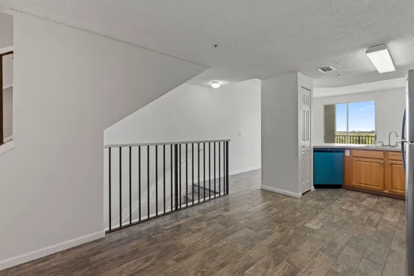 a view of a kitchen with a sink and a refrigerator