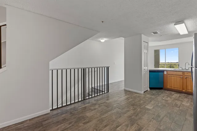 a view of a kitchen with a sink and a refrigerator