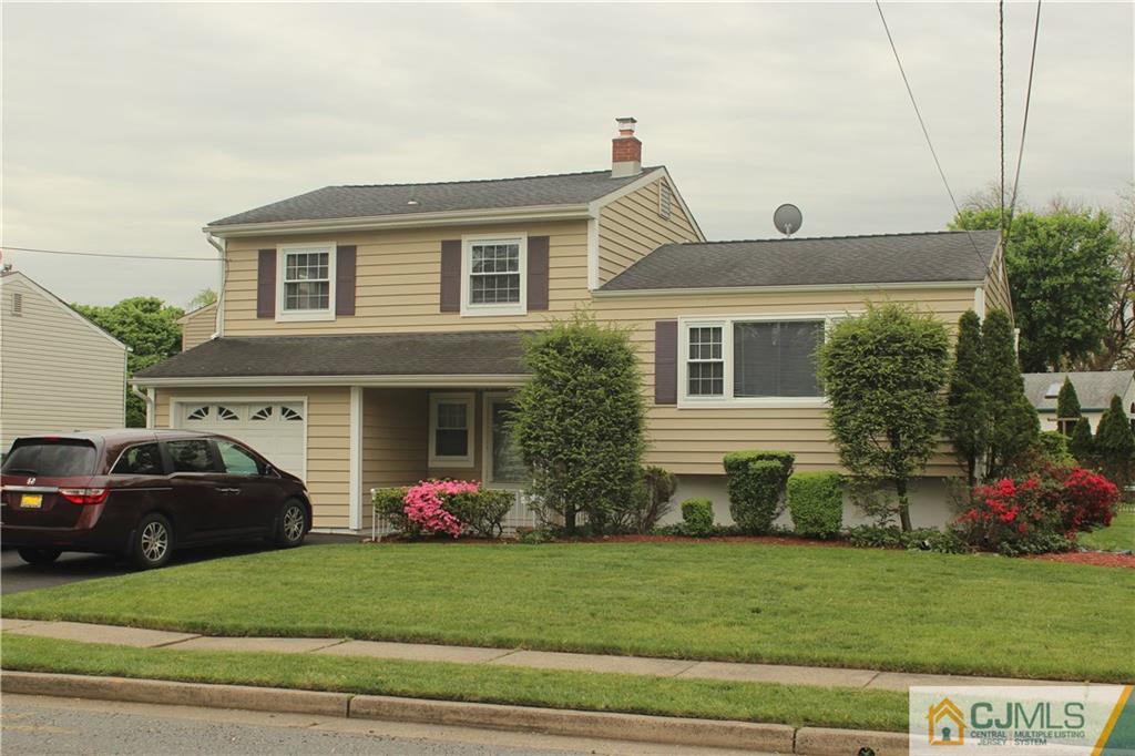 7 Lydia Lane Edison, NJ 08817 - Photo 2 of 17 a front view of a house with a garden
