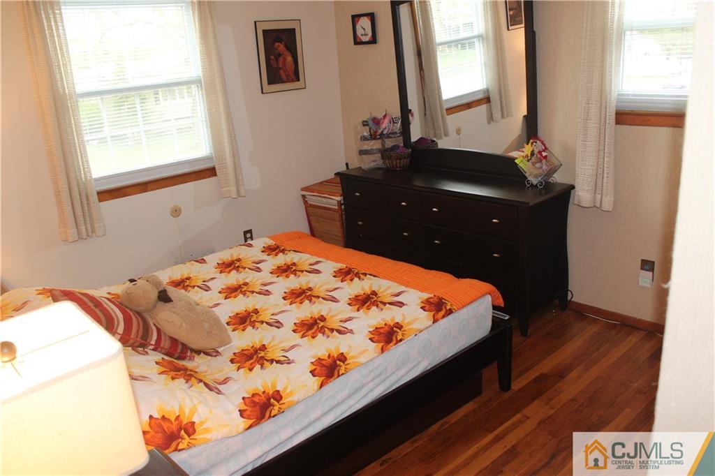 7 Lydia Lane Edison, NJ 08817 - Photo 14 of 17 a bed sitting in a bedroom next to a window