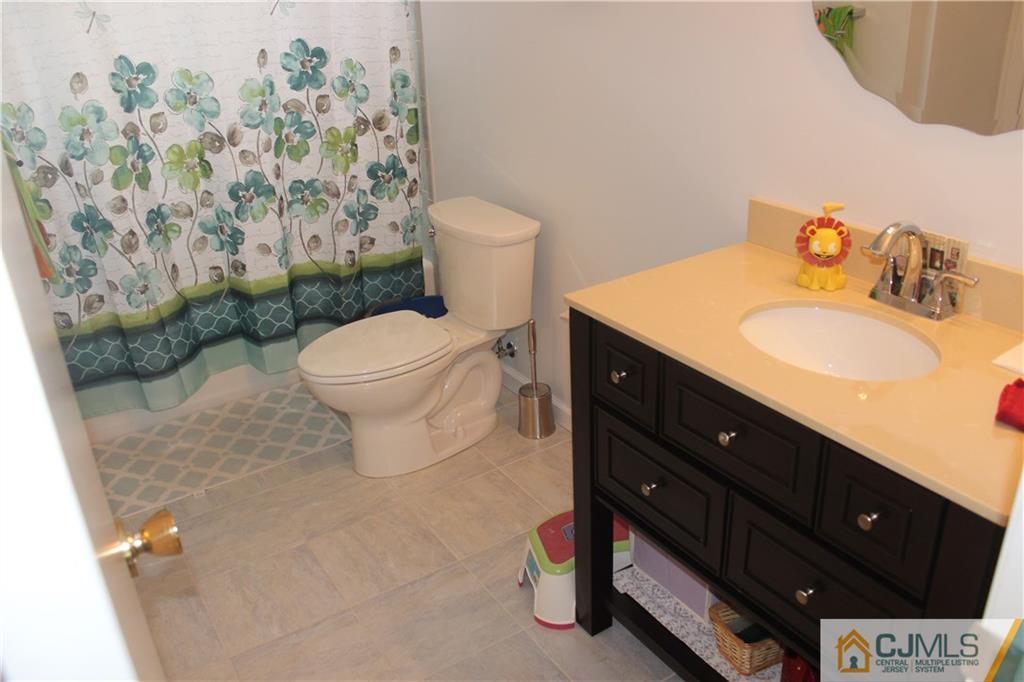 7 Lydia Lane Edison, NJ 08817 - Photo 15 of 17 a bathroom with a sink vanity mirror and toilet