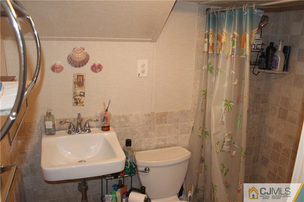 7 Lydia Lane Edison, NJ 08817 - Photo 16 of 17 a bathroom with a sink a toilet and shower