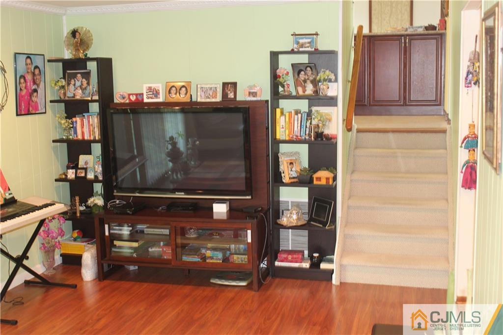 7 Lydia Lane Edison, NJ 08817 - Photo 5 of 17 a room with wooden floor and a cabinet door